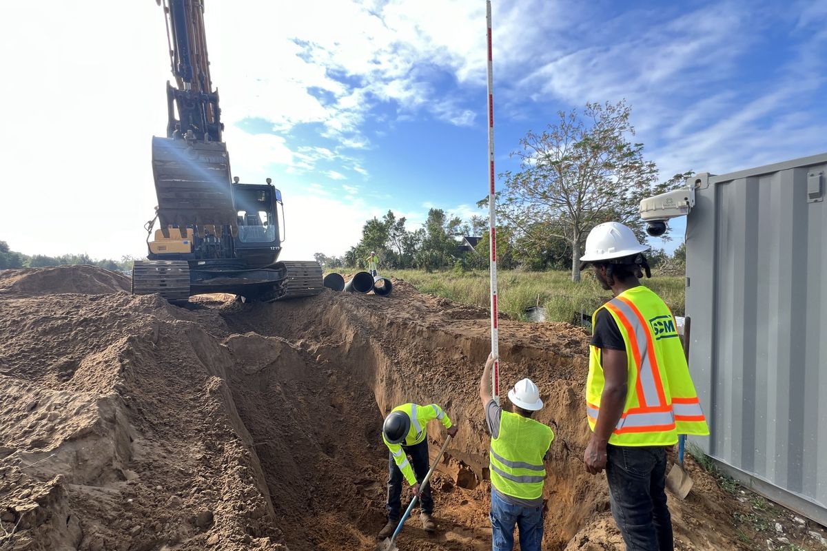 Central Florida Civil crew setting grade over a storm pipe trench
